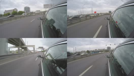 汽车在城市高速公路上行驶。从车身的侧视图高清在线视频素材下载