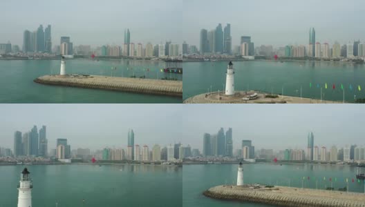 白天青岛市区海岸线湾纪念碑灯塔码头观看4k中国航拍全景图高清在线视频素材下载