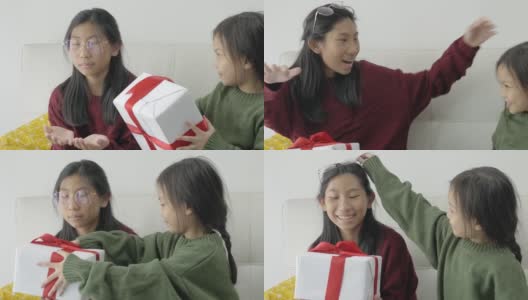 亚洲女孩在家里给她的妹妹惊喜礼物，假日概念。高清在线视频素材下载