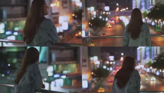 微笑的年轻美丽的亚洲女性游客走在城市的夜晚，看着路灯照明。快乐的漂亮女孩享受和享受城市夜生活的乐趣。高清在线视频素材下载