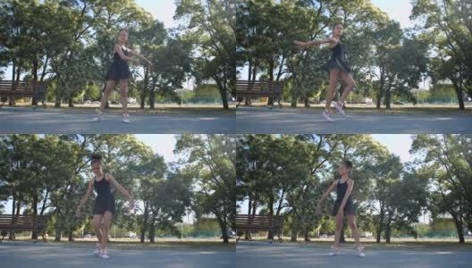8岁的美丽白人女孩穿着黑色芭蕾舞服在一个阳光明媚的夏天在城市公园跳芭蕾舞。慢动作200帧/秒高清在线视频素材下载