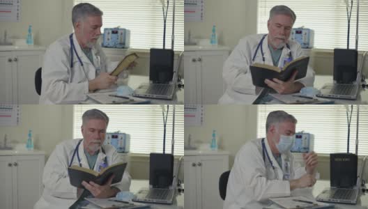 在一间小诊所里，一名因患新冠肺炎而戴口罩、劳累过度的医生坐在办公桌前，拿起一本《圣经》阅读，寻求鼓励和慰藉。高清在线视频素材下载