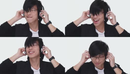 兴奋的亚洲人喜欢听音乐与耳机在白色的背景高清在线视频素材下载