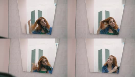 红发女人在浴室里擦头发高清在线视频素材下载