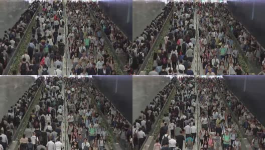 在香港的交通高峰期，一群步行上下班的人在香港火车站高清在线视频素材下载