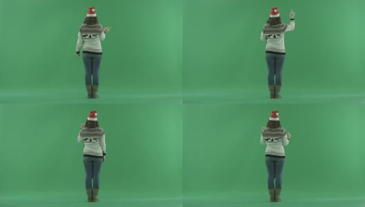 戴着圣诞帽的严肃年轻女子在虚拟环境中从背后做手势，背景上有色度键高清在线视频素材下载
