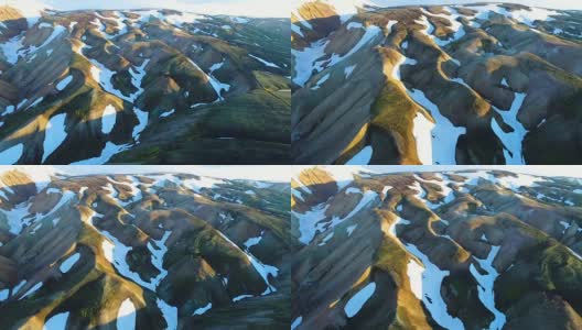 山谷国家公园landmanalaugar的4k航拍。平缓的山坡上是雪原和冰川。壮丽的冰岛在夏天高清在线视频素材下载