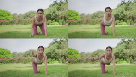 美丽的亚洲女人在花园里做瑜伽练习。高清在线视频素材下载