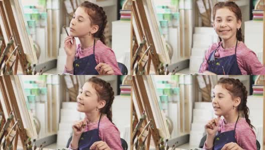 可爱的小女孩在美术课上画画时竖起大拇指高清在线视频素材下载