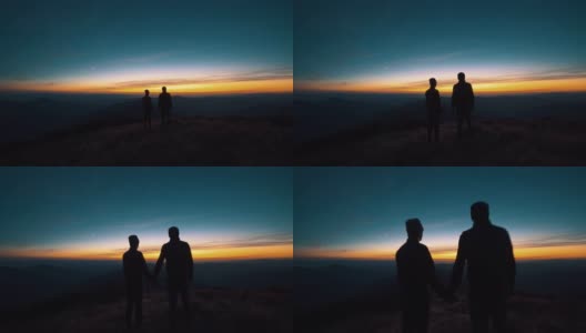 这对夫妻站在夕阳背景下的山上高清在线视频素材下载