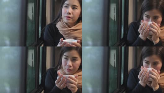 年轻的亚洲女人喝咖啡高清在线视频素材下载