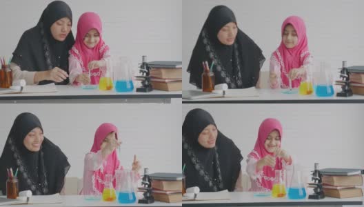 年轻的穆斯林教师教她的学生在白色背景的房间里测试一些科学实验高清在线视频素材下载