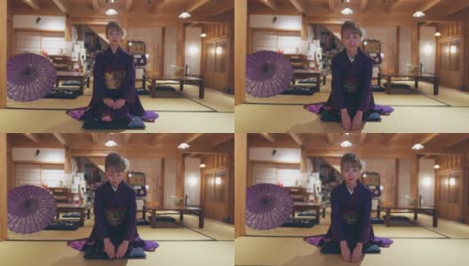 穿着Furisode和服的年轻女子坐在高跟鞋上，在日本的榻榻米房间鞠躬高清在线视频素材下载