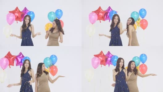 亚洲女子在白色背景气球的新年晚会上跳舞高清在线视频素材下载