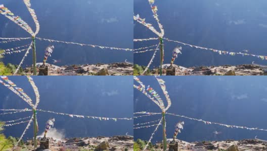 尼泊尔夏尔巴人村庄Namche Bazar上空，五颜六色的佛教经幡在强风中飘扬，直升飞机降落，扬起尘土。高清在线视频素材下载