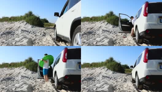 在沙滩上，有人穿着脚蹼从车里走出来高清在线视频素材下载