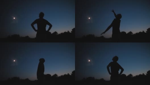 一个男人的剪影和乡村星空下年轻的月亮。高清在线视频素材下载