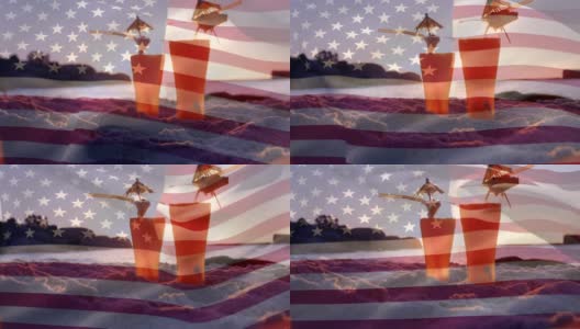 海滩上的两杯鸡尾酒和7月4日的一面美国国旗高清在线视频素材下载