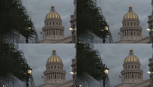 跟踪经过热带树显示古巴国会大厦的穹顶和国旗在不祥的云高清在线视频素材下载