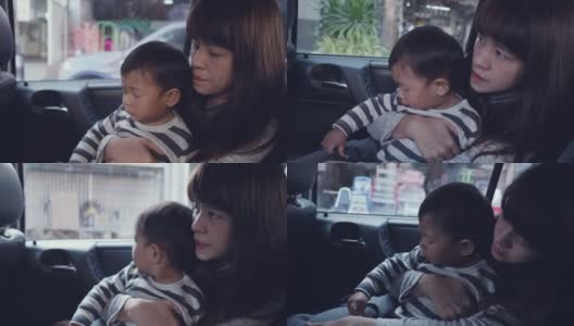 年轻的亚洲母亲带着男婴开车旅行。高清在线视频素材下载