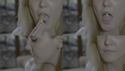一个生病的女人的嘴吞下一颗黄色的抗生素胶囊，喝一杯椰子水的特写高清在线视频素材下载
