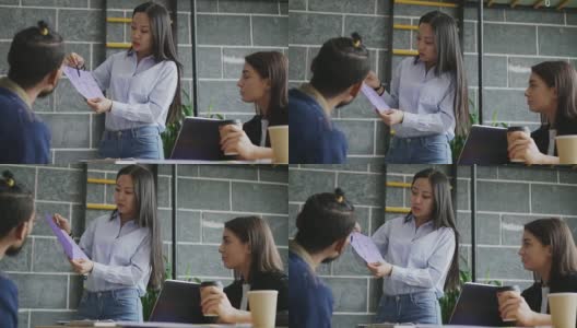 年轻的亚洲女人在现代初创办公室向同事展示房子的纸质建筑计划高清在线视频素材下载