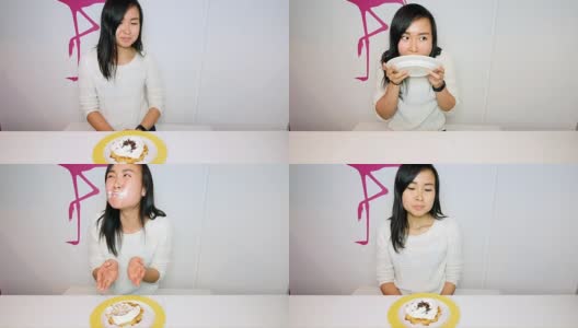 健康的年轻女子与食物的诱惑作斗争高清在线视频素材下载