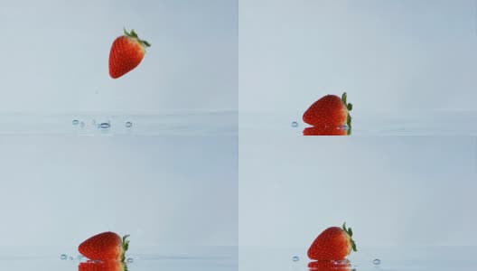 草莓落下和在水上滚动的慢镜头。高清在线视频素材下载