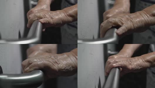 老妇人扶着扶手走路高清在线视频素材下载