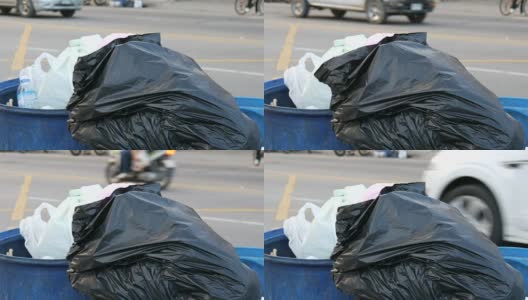 那个女人扔了一个塑料瓶。满垃圾桶的大垃圾袋装满了剩菜和垃圾在街上高清在线视频素材下载