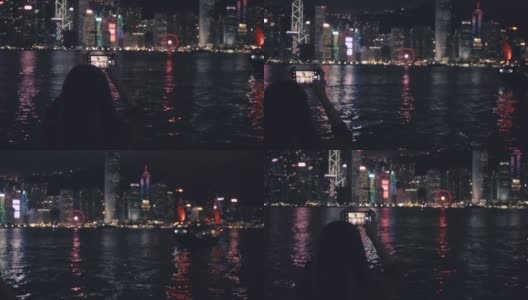 旅行者们用手机拍摄香港的夜景。高清在线视频素材下载