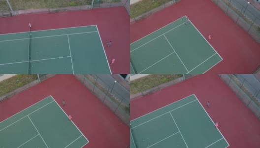 一个男孩和一个女孩正在打网球高清视频与平移无人机视图高清在线视频素材下载