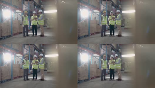 亚洲华人管理人员与仓库工人进行严肃的讨论与白帽使用数字平板电脑高清在线视频素材下载