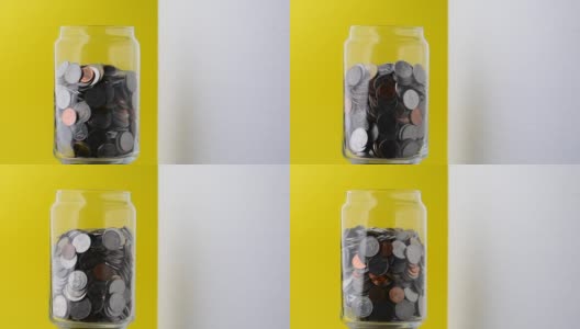 玻璃瓶里的硬币慢慢地围绕着它旋转。钱装在一个玻璃瓶里。省钱。为未来储蓄的想法。高清在线视频素材下载