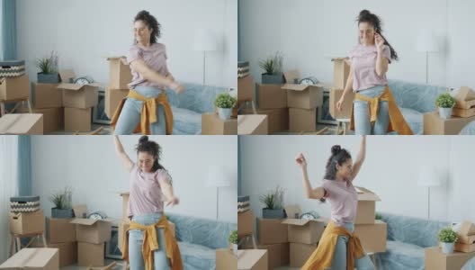 兴奋的年轻女子在搬迁后的新公寓跳舞的慢动作肖像画高清在线视频素材下载