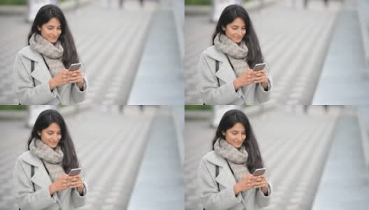 微笑的拉丁妇女使用手机高清在线视频素材下载