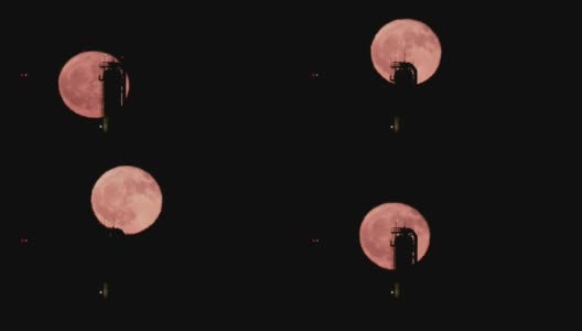 红色的满月从大型炼油厂后面升起高清在线视频素材下载