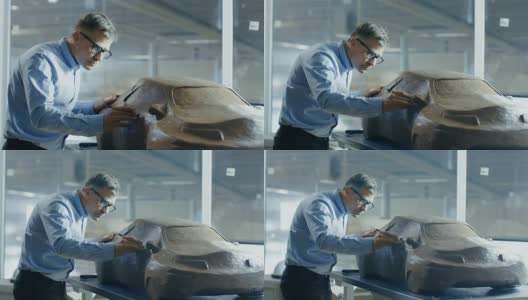 首席汽车设计师与Rake雕刻未来汽车模型从橡皮泥粘土。他在一家大型汽车厂的专门工作室工作。高清在线视频素材下载