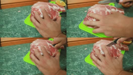 男性用手在砧板上切生肉。特写镜头。高清在线视频素材下载