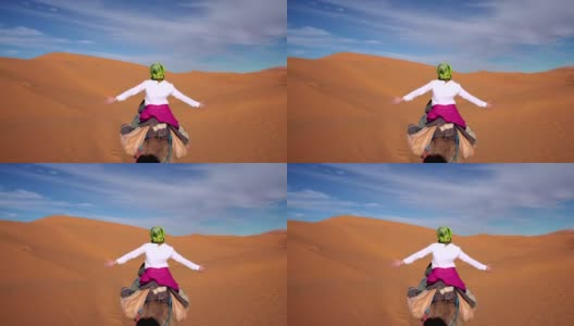 沙漠之旅。女人喜欢骑骆驼高清在线视频素材下载