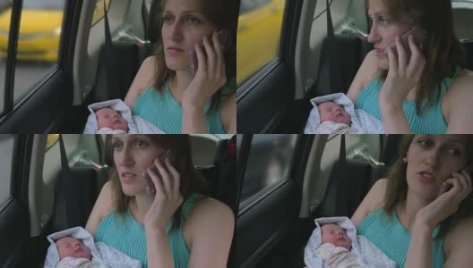 手里拿着婴儿打电话的女人高清在线视频素材下载