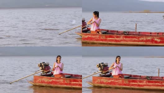 亚洲女渔民正在驾驶一艘船捕鱼高清在线视频素材下载