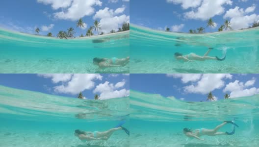 半水下:年轻女子浮潜在令人窒息的水晶般清澈的水中。高清在线视频素材下载