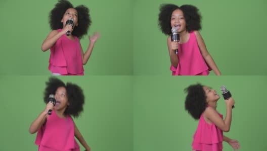 年轻可爱的非洲女孩与非洲发式愉快地唱歌高清在线视频素材下载