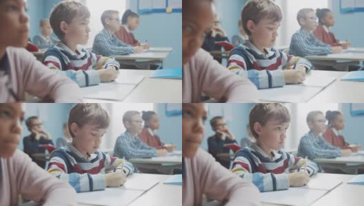 小学课堂:聪明的白人男孩在练习笔记本上写的肖像，参加考试和写作考试。多样化的聪明的孩子们努力工作和学习高清在线视频素材下载