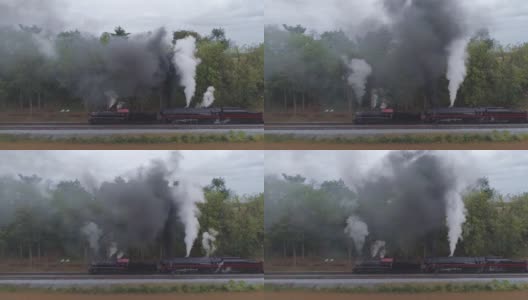 两辆蒸汽机车的空中侧视图，双头货运列车冒着黑烟和蒸汽高清在线视频素材下载