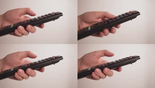 电视遥控器特写手指按下按钮白色高清在线视频素材下载