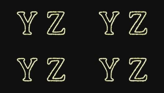 英文字母“yz”出现在中心，一段时间后消失。抽象的孤立的模糊的节日彩灯在字母表的形式。高清在线视频素材下载