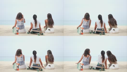 一群快乐的亚洲女性朋友在玩完滑板后坐在沙滩上聊天高清在线视频素材下载