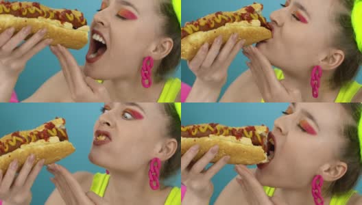 饥肠辘辘的女人吃着蘸酱的大热狗。高清在线视频素材下载